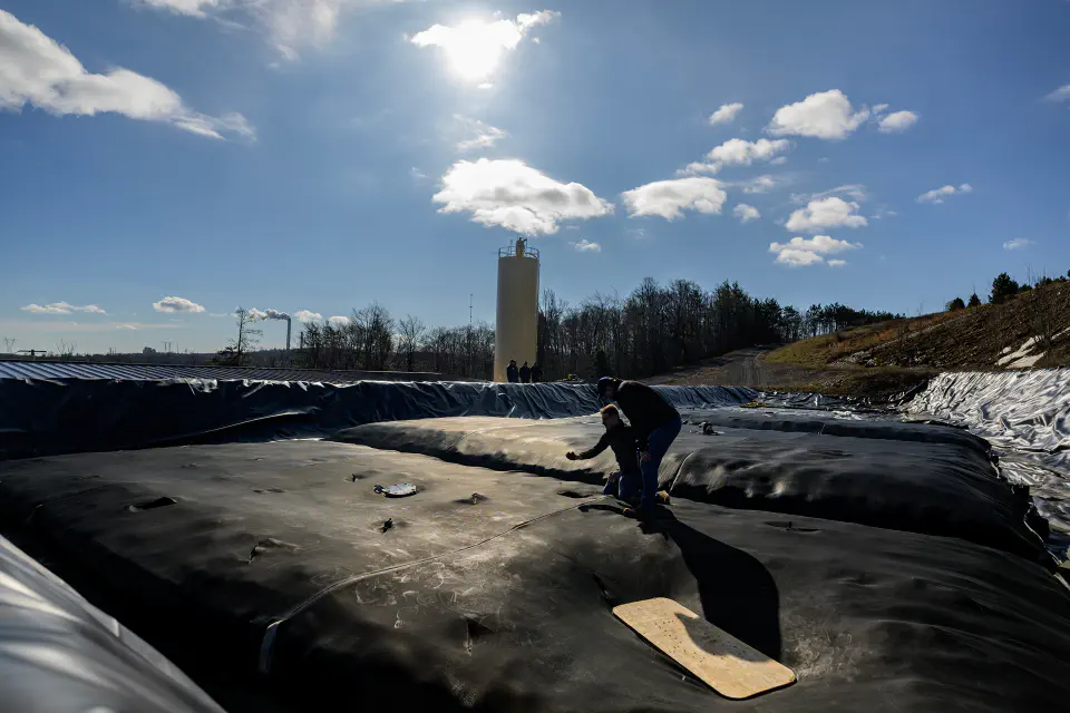Two researchers talking on top of the A34 treatment facility.